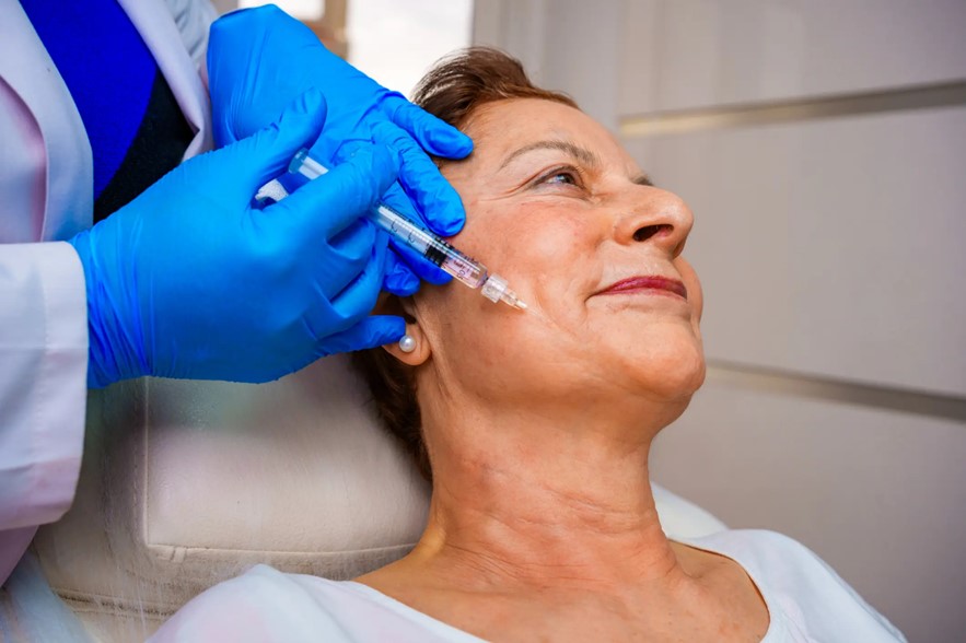 Mature woman receiving injectable for wrinkles